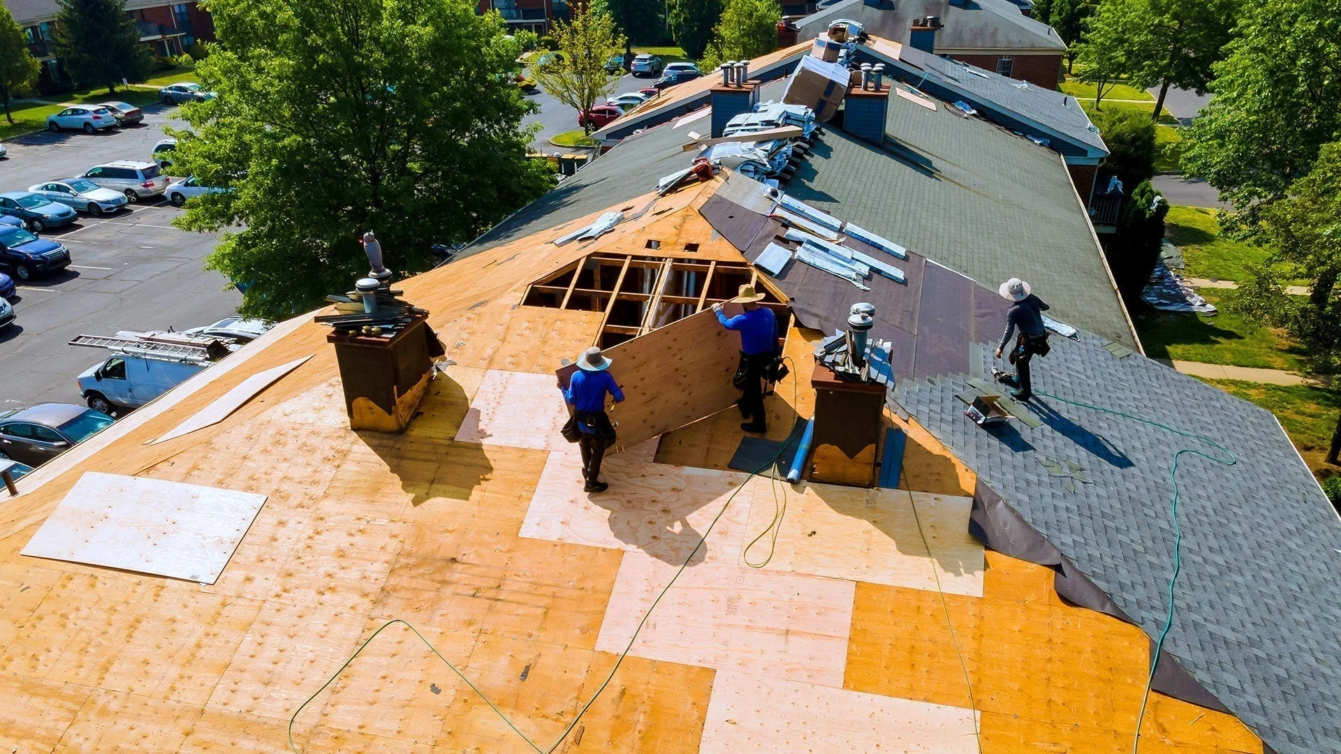 Roofing contractor inspecting a residential roof after storm damage